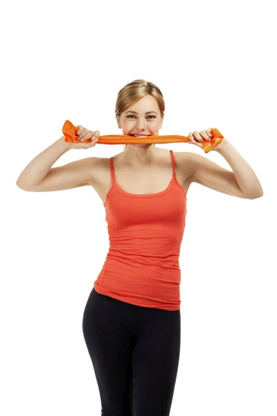 Fitness woman bites in ribbon — Stock Photo, Image