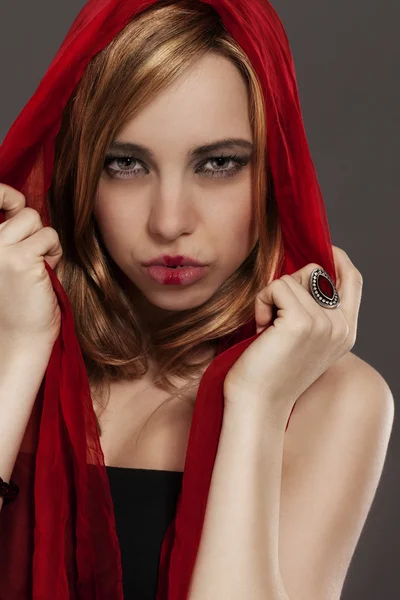 Beautiful woman with a red scarf — Stock Photo, Image