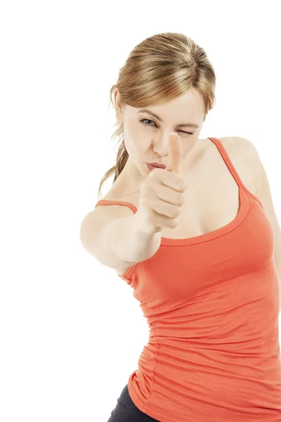 Mujer rubia fitness apuntando con su pulgar —  Fotos de Stock