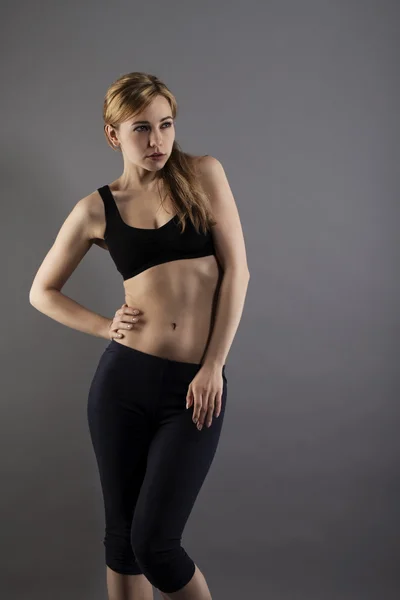 Young fitness woman in fashion pose — Stock Photo, Image