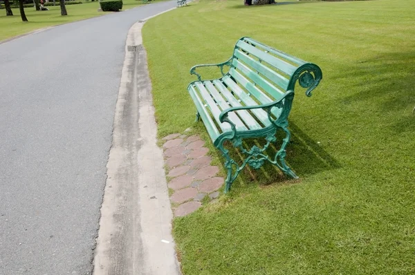 Chair in the park beside walkway — Stock Photo, Image