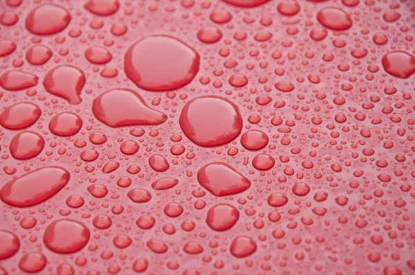 Vatten buble konsistens på röd yta — Stockfoto