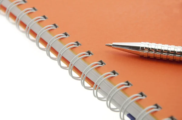 Pen push on notebook Stock Picture