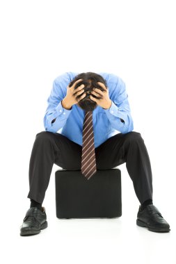 Business man sitting on briefcase with headache clipart