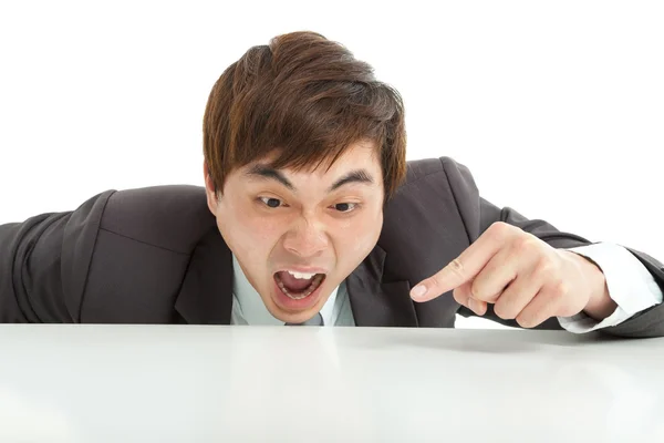 Angry businessman pointing something on the table — Stock Photo, Image