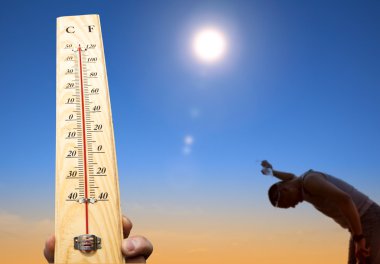 Man throwing water over his head for cooling under heat and summer sky clipart