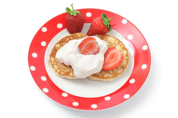 Fritters with sour cream and a strawberry on a plate — Stock Photo, Image