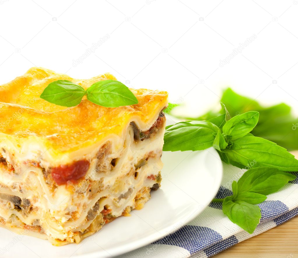 Delicious Italian Lasagna / with fresh basil / white background