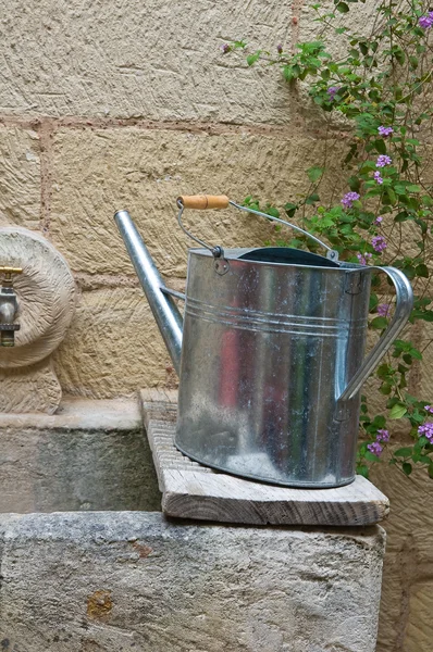 Watering can on washhouse. — Stock Photo, Image