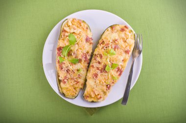 Stuffed zucchini halves. clipart