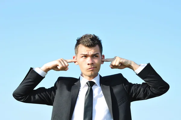 Hombre de negocios cubre oídos —  Fotos de Stock