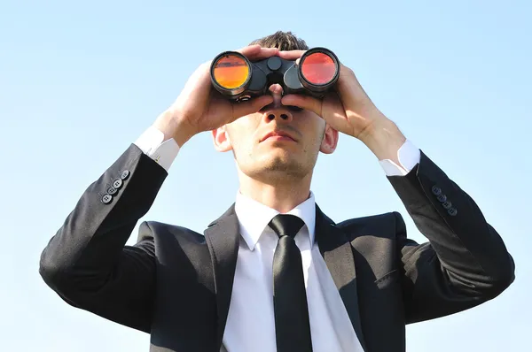 Business man with binoculars — Stock Photo, Image