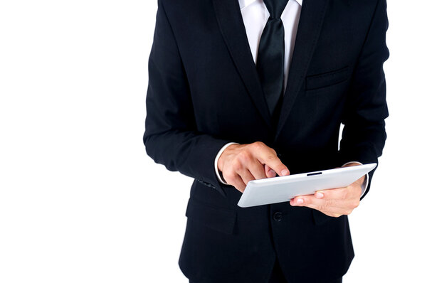 Isolated young business man using tablet