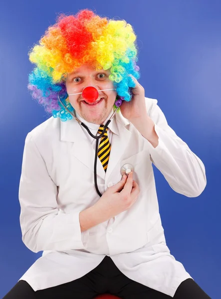 Clown doctor on blue with stethoscope — Stock Photo, Image