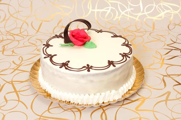White cake with chocolate ornaments — Stock Photo, Image