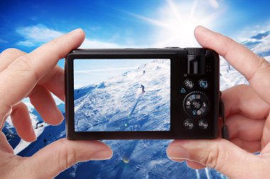 Taking photo of a skier clipart