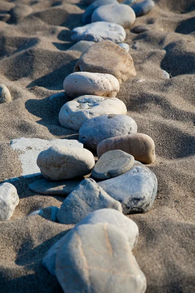 Pebbles in the sand — Stock Photo, Image