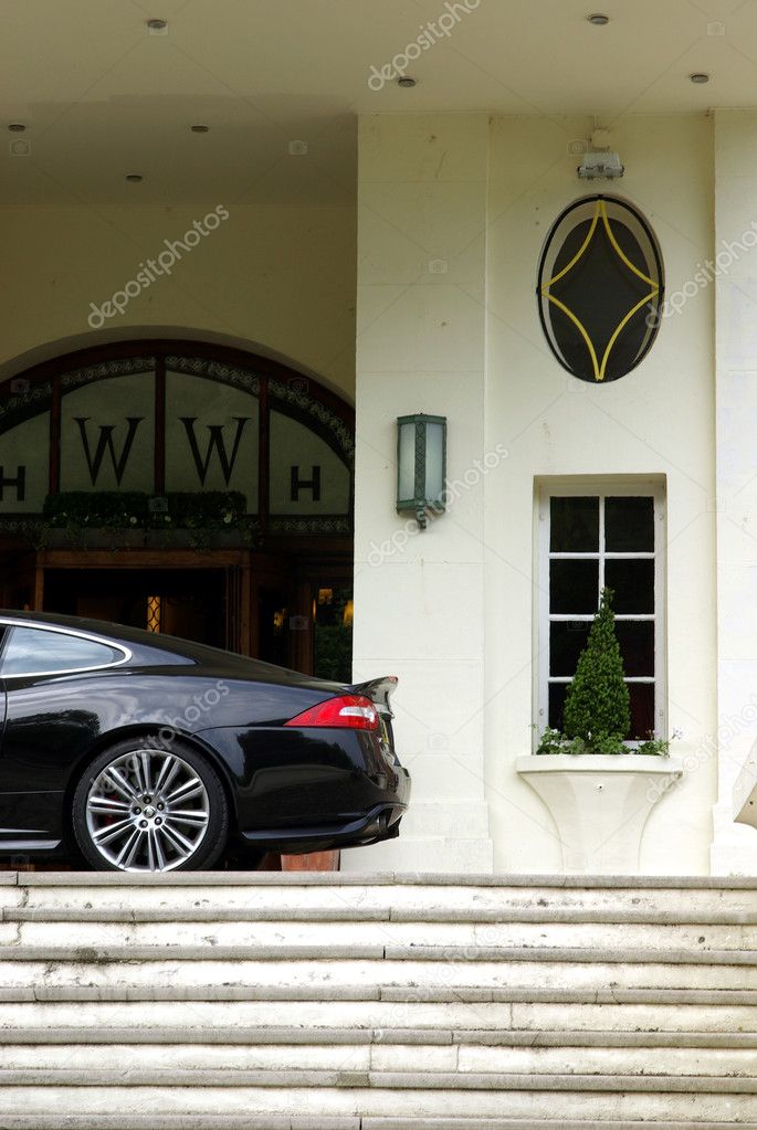 Sport car in front of a fancy hotel
