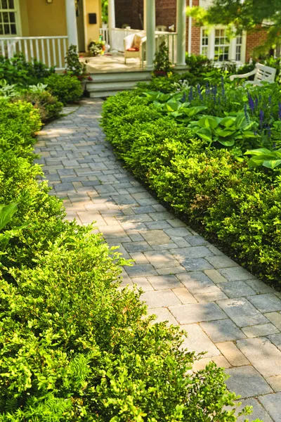 Stone path in landscaped home garden Stock Photo