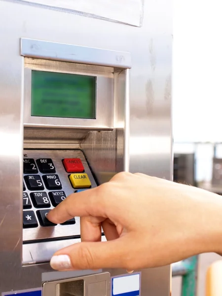 Woman entering PIN on a ticket vending machine — Stock Photo, Image