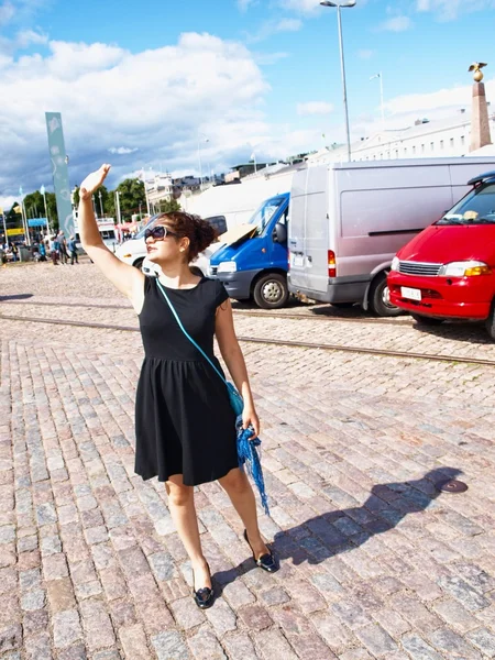 Mulher em um estacionamento, sombreando do sol — Fotografia de Stock