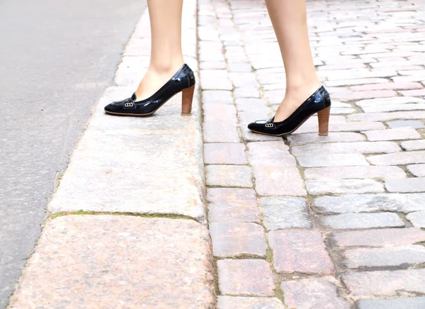 stock image Female stepping onto the sidewalk in a street