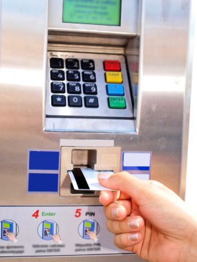 Person inserting, removing a card from ticket vending machine clipart