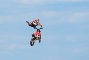 Motocross racer performs a jump clipart