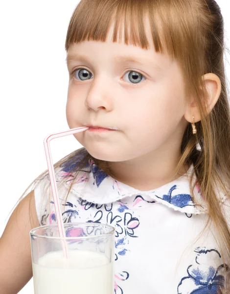 Cute little girl drinks milk using drinking straw — Stock Photo, Image