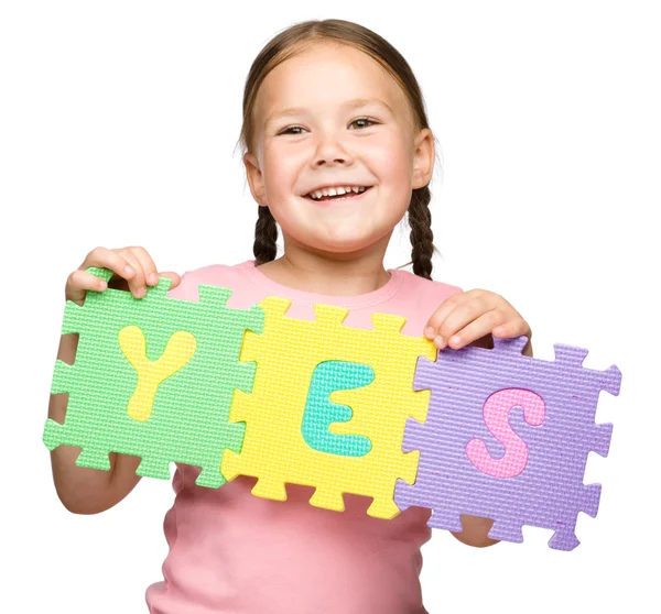 stock image Cute little girl is holding Yes slogan
