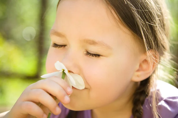 Retrato de uma menina bonito cheirar flores — Fotografia de Stock