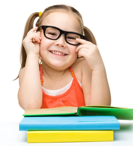 Cute cheerful little girl reading book — Stock Photo, Image