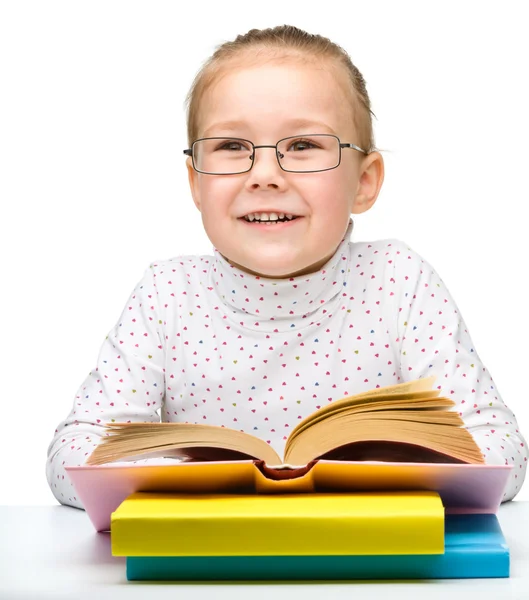Cute cheerful little girl reading book — Stock Photo, Image