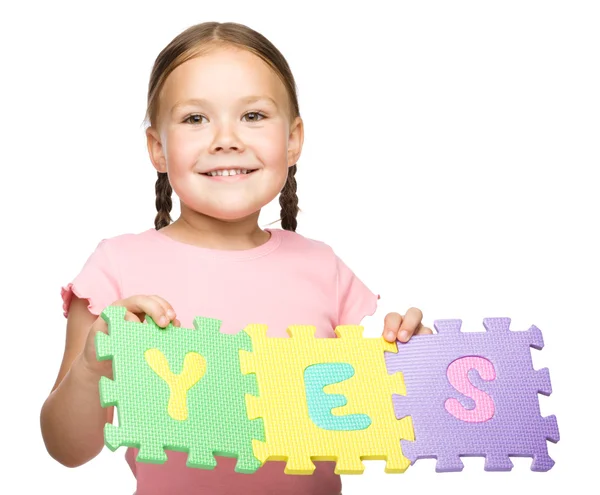 stock image Cute little girl is holding Yes slogan