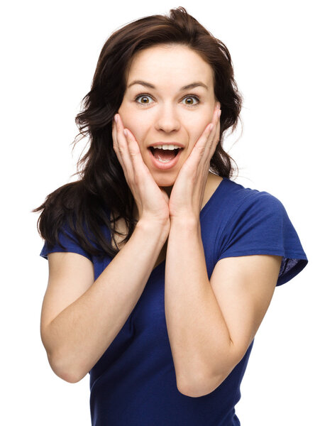 Woman is holding her face in astonishment