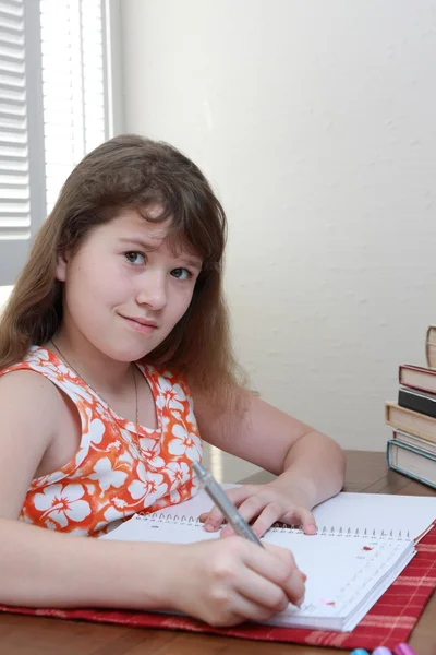 stock image Teenage girl is doing a homework