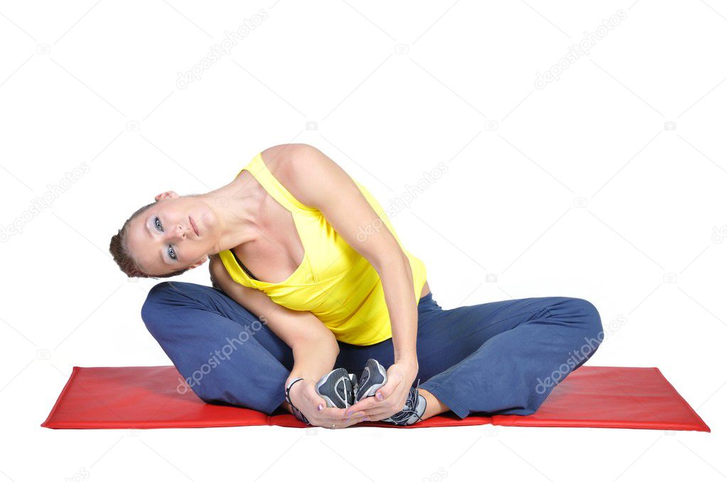 Fit young female yoga instructor showing different exercises on a white background