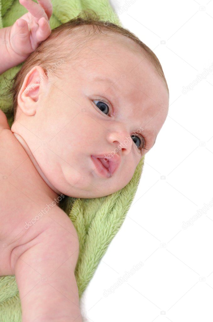 Portrait of cute newborn baby girl on a white background