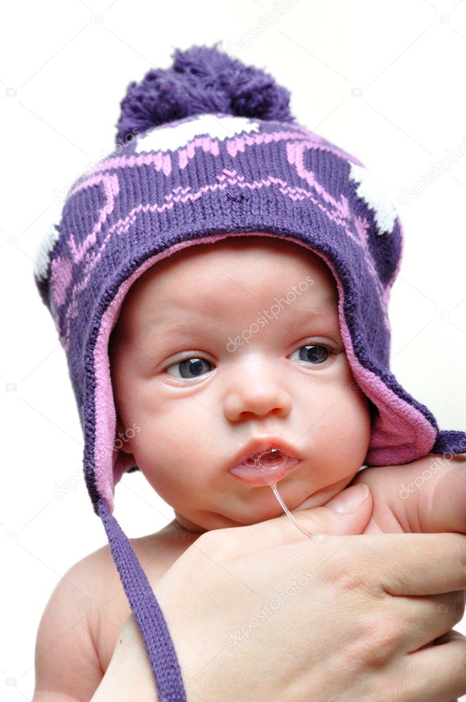 Portrait of newborn baby girl wearing violet winter hat