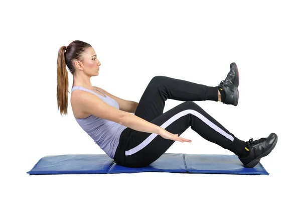 Fit young female pilates instructor showing different exercises — Stock Photo, Image
