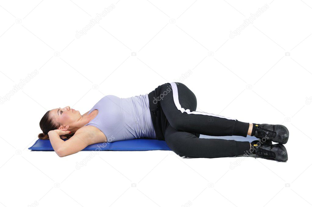 Fit young female pilates instructor showing different exercises