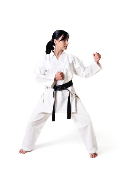 Karate donna posa su uno sfondo bianco — Foto Stock