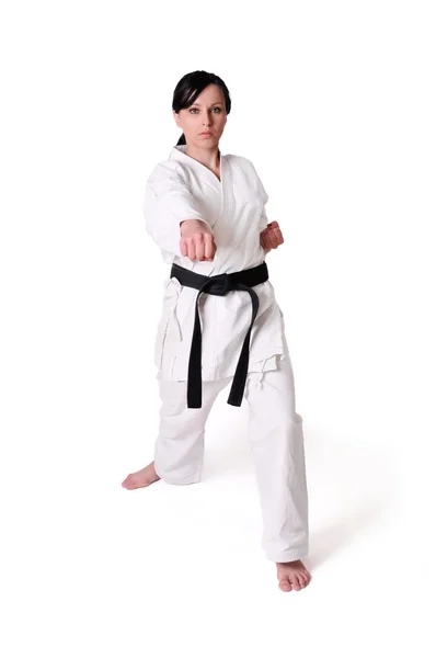 Karate kadın beyaz bir arka plan üzerinde poz — Stok fotoğraf