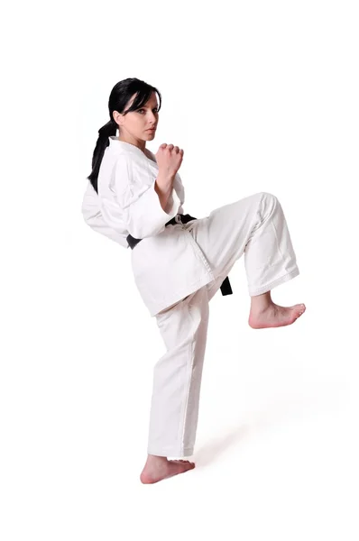 Karate žena pózuje na bílém pozadí — Stock fotografie