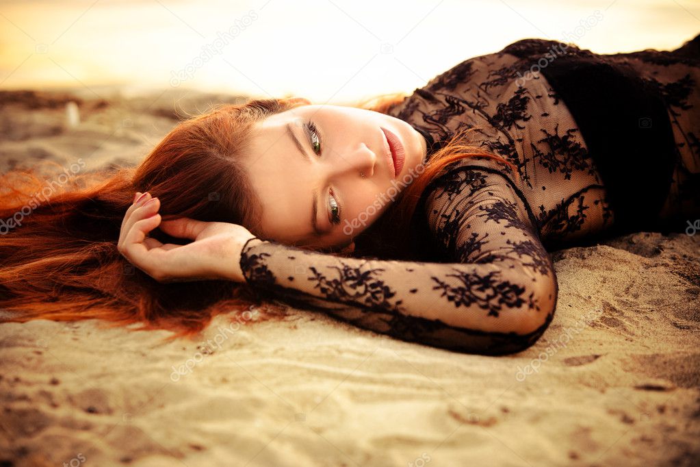 Redhead woman on sand