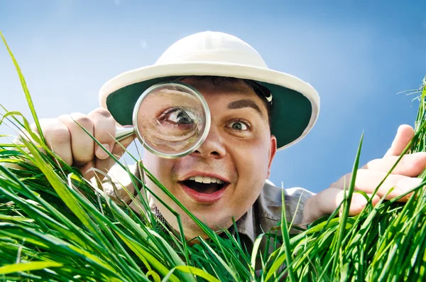 Young Man Looking through a Magnifying Glass — Stock Photo, Image