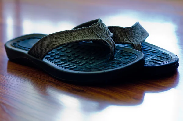 Stock image Flip Flops on Hardwood Floor