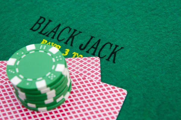 Black jack table with red casino chips — Stock Photo, Image