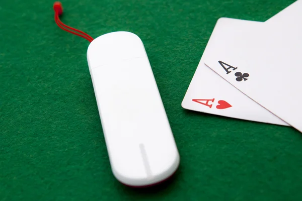 Texas holdem pocket aces on casino table with internet stick con — Stock Photo, Image
