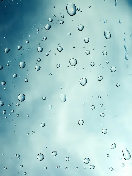 stock image Water drops with sky and clouds background